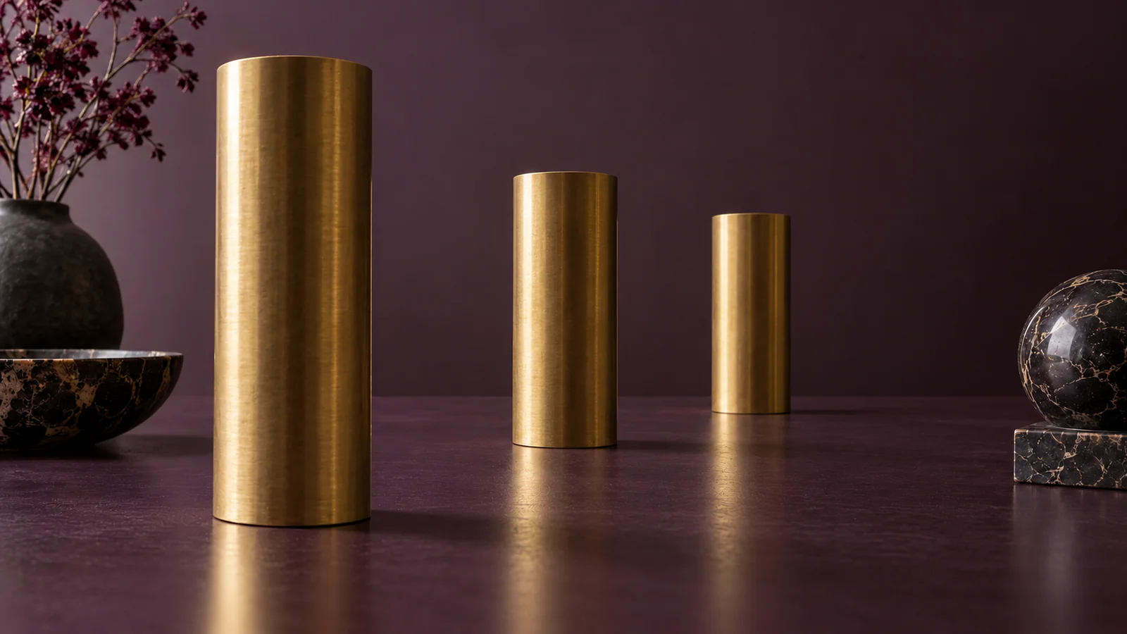 Brass cylinders recede into depth, illustrating how perspective changes apparent size