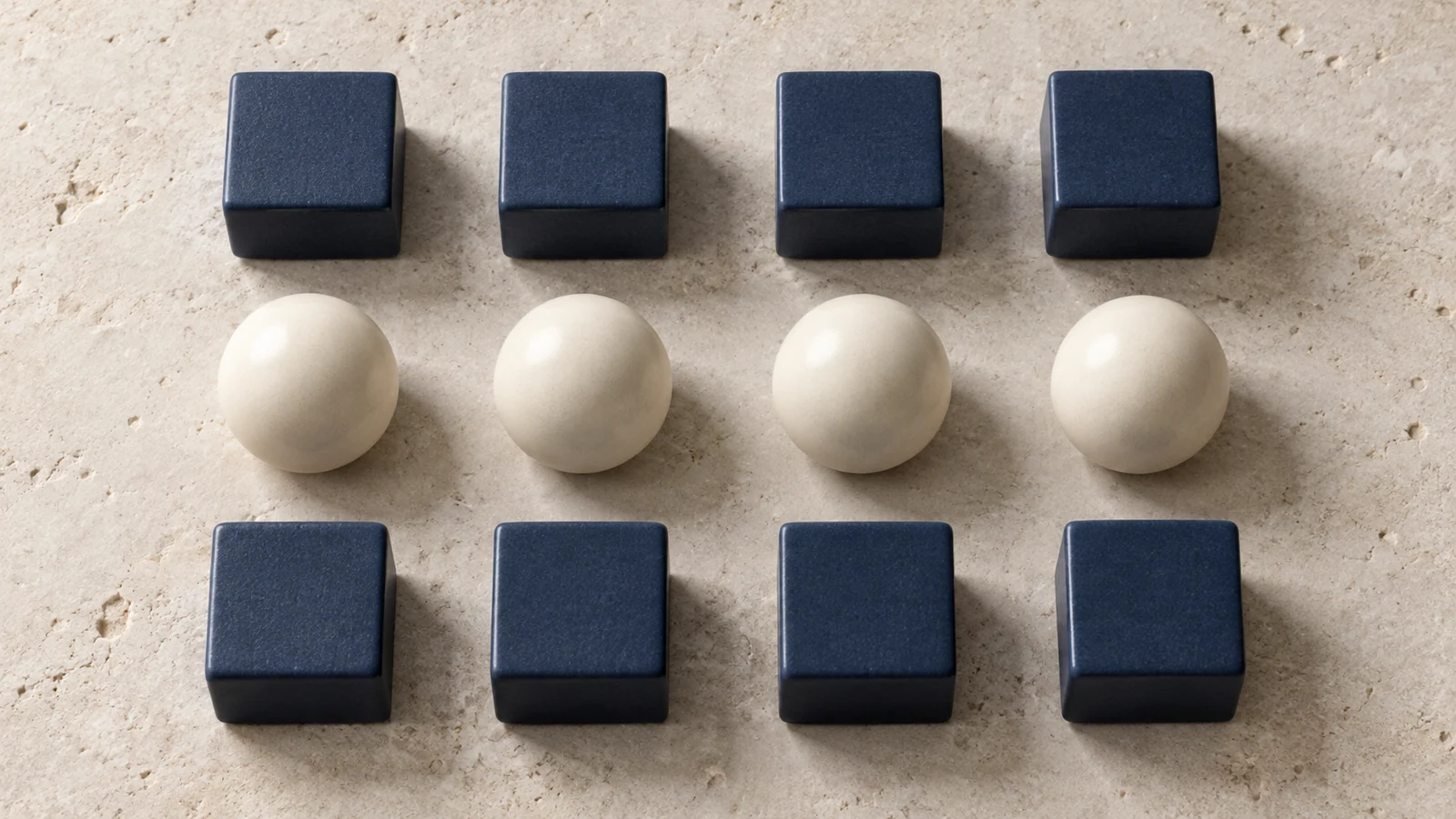 AI tactile arrangement of matching cubes and spheres forming clear visual rows.